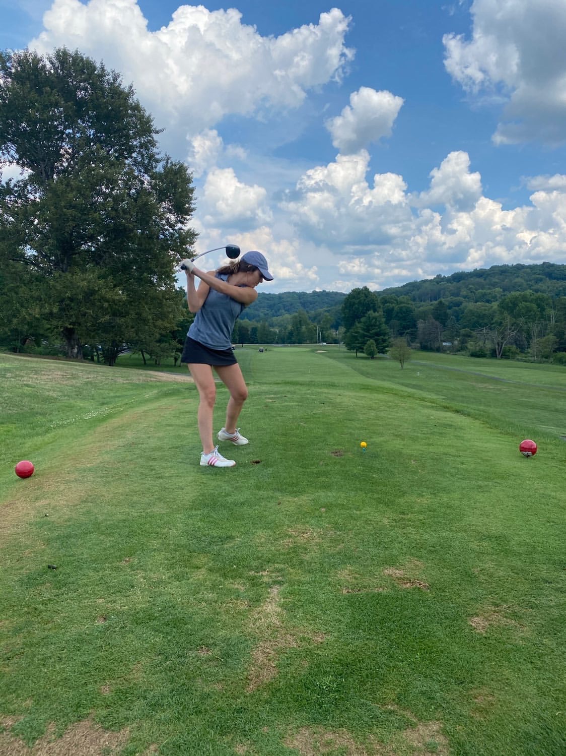 Woman hitting golf ball