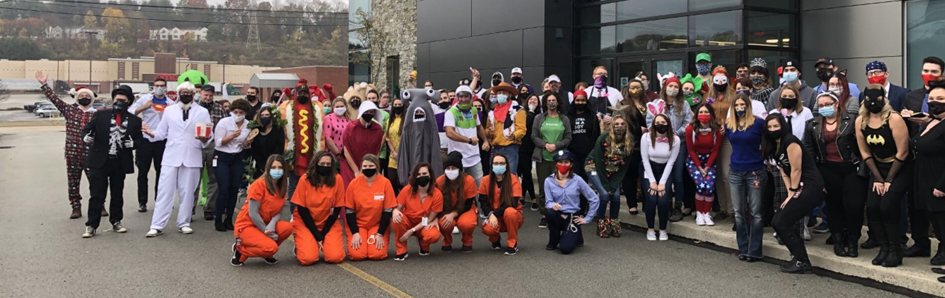 DNA employees posing for picture with Halloween costumes