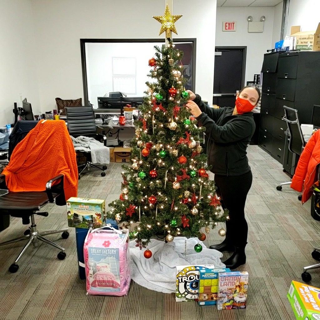DNA employee decorating Christmas tree