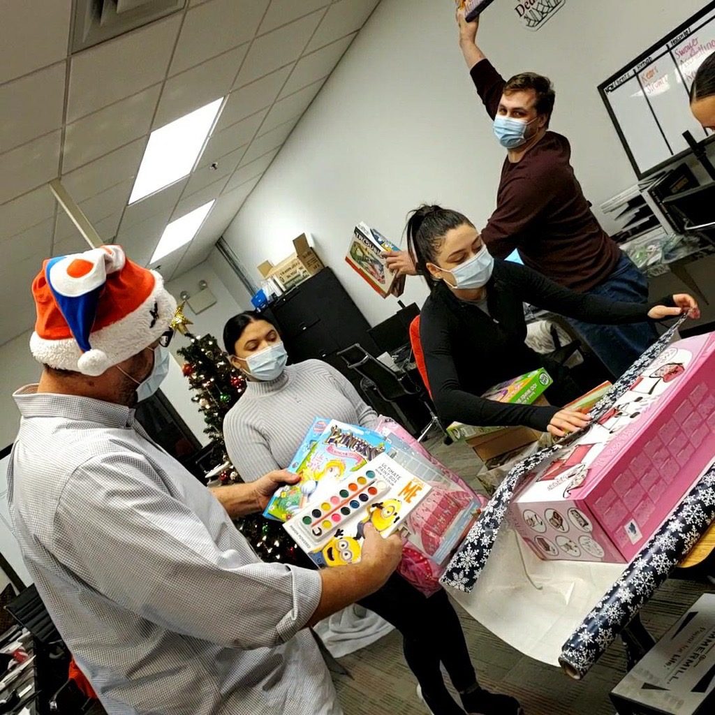 DNA employees wrapping Christmas presents