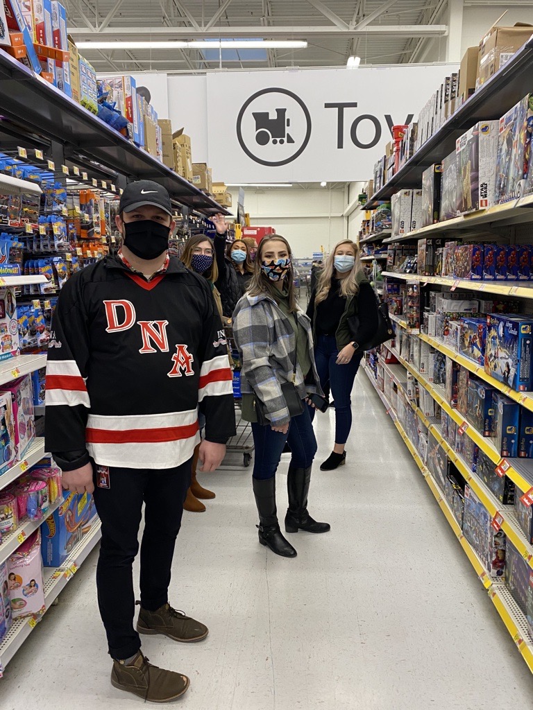 DNA employees posing for picture in toy aisle