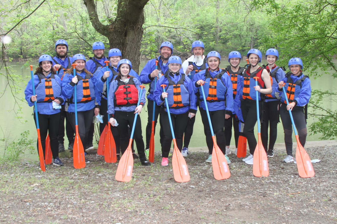 Dedicated Nursing Associates employees posing for picture with white water rafting equipment