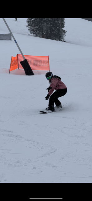 Dedicated Nursing Associate employee snowboarding down a mountain