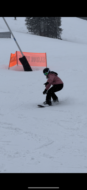 Dedicated Nursing Associate employee snowboarding down a mountain