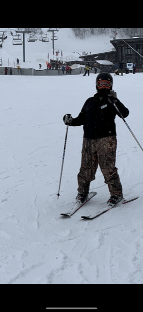 Dedicated Nursing Associate employee posing for a picture while skiing
