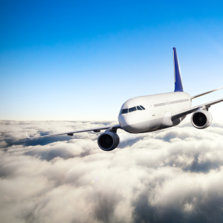 White airplane flying above the clouds