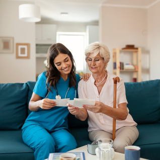 Nurse and an elderly woman in her home