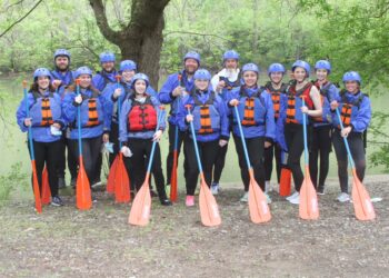 Dedicated Nursing Associates employees posing for picture with white water rafting equipment